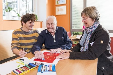 Älterer Mann und zwei Frauen beim Malen auf Palliativstation Martha-Maria Halle-Dölau.